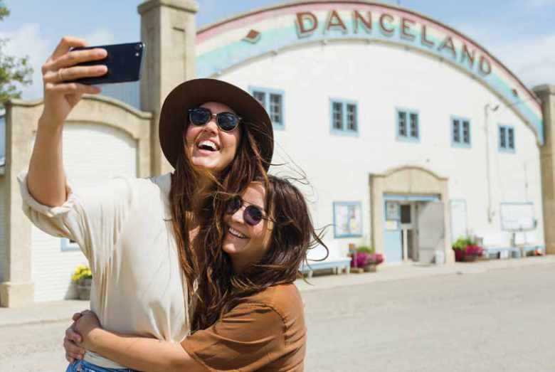 Two women outside danceland taking a selfie