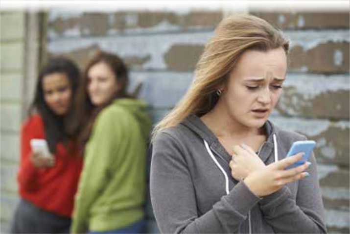 Girl receiving a mean text message from cyber bullies