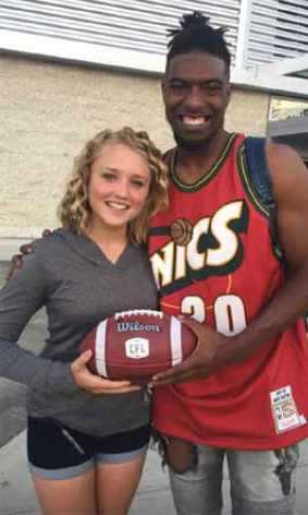 Duran Carter and Paige Hansen holding a football